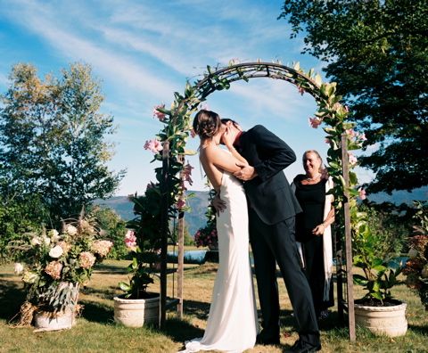 Newlyweds kissing at alter